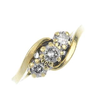 An 18ct gold diamond crossover ring. The graduated brilliant-cut diamond line, to the asymmetric sho