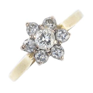 A diamond cluster ring. Of floral design, the brilliant-cut diamond, within a similarly-cut diamond