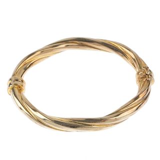 A 9ct gold hinged bangle. Of rope-twist design and push-piece clasp. Import marks for London, 1993.