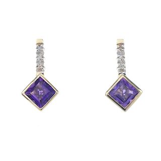 A pair of diamond and amethyst ear pendants. Each designed as a kite-shaped amethyst, suspended from