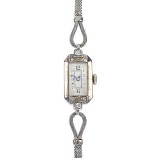 A mid 20th century diamond manual wind cocktail watch. The rectangular-shape white dial with Arabic