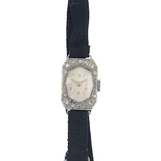 A lady's mid 20th century diamond manual wind cocktail watch. The oval-shape white dial with golden