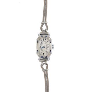 A lady's early 20th century diamond and synthetic sapphire manual wind wrist watch. The oval-shape w