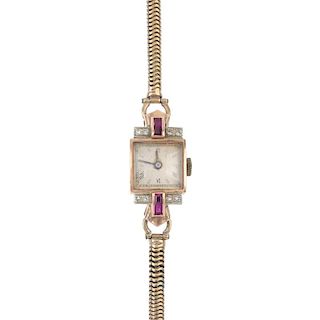A lady's mid 20th century synthetic ruby and diamond manual wind cocktail watch. The square-shape gr