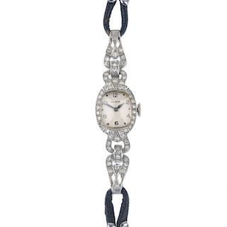 A lady's mid 20th century diamond manual wind cocktail watch. The oval-shape white dial and black Ar