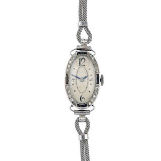 A lady's mid 20th century diamond and onyx manual wind cocktail watch. The oval-shape cream dial and
