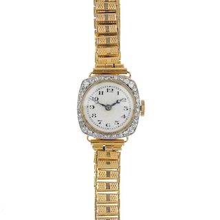 A lady's early 20th century 18ct gold diamond manual wind wristwatch. The circular white dial and bl