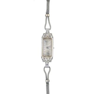 A lady's 1930s 18ct gold diamond manual wind cocktail watch. The rectangular-shape silvered dial and