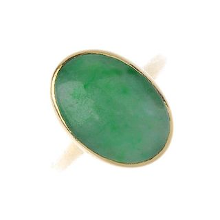 A jade single-stone ring. The oval jadeite cabochon, within a collet setting, to the tapered shoulde