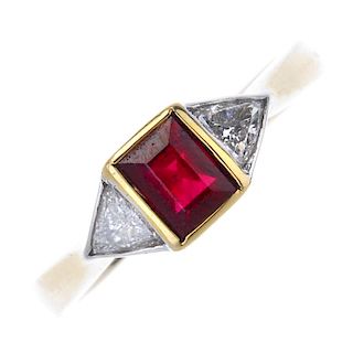 An 18ct gold ruby and diamond three-stone ring. The rectangular-shape ruby, with triangular-shape di