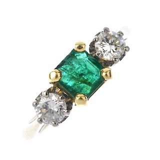 An emerald and diamond three-stone ring. The square-shape emerald, with brilliant-cut diamond sides,