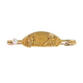 An early 20th century gold brooch. The oval-shaped panel, depicting three ducklings and a puppy, wit