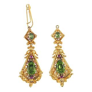 A pair of early 20th century gold peridot and ruby ear pendants. Each designed as a pear-shape perid