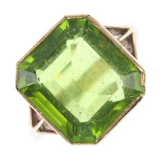 A peridot single-stone ring. The square-shape peridot, to the trifurcated shoulders and plain band.