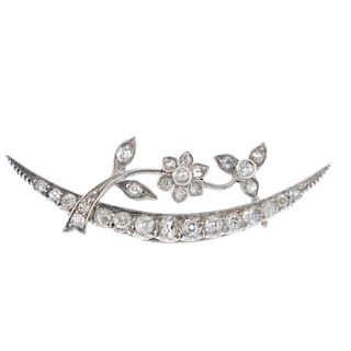 A late 19th century silver and gold diamond crescent brooch. The old-cut diamond spray, to the old-c