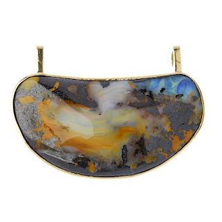 A boulder opal pendant. The free form boulder opal, to the plain surmount accents. Approximate opal