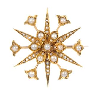 An early 20th century 15ct gold split pearl star brooch. The split pearl flower, within a similarly-