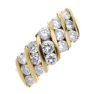 An 18ct gold diamond ring. The brilliant-cut diamond three-row lines, with bar spacers, to the plain