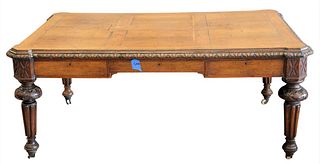 Oak Library Table/Desk, having carved frame set on fluted legs and casters, height 29 inches, top 45" x 68".