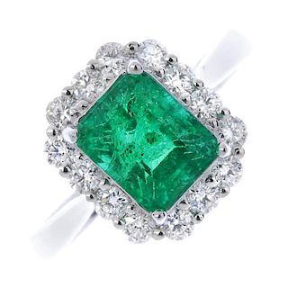 * An emerald and diamond cluster ring. The rectangular-shape emerald, within a brilliant-cut diamond