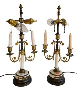 Pair of Neoclassical Style Alabaster Candle Sticks, made into table lamps, having two lights each and round bronze bases, overall height 20 inches.