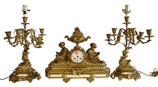 Three Piece Brass Mantle Set, to include a clock and two candelabras, each electrified into lamps and having figures mounted to the base, lamp height 