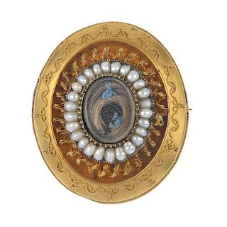A mid Victorian 12ct gold pearl mourning brooch, circa 1860. The woven hair panel, within a pearl bo