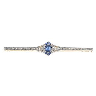 An early 20th platinum and 18ct gold sapphire and diamond brooch. The circular-shape sapphire, withi