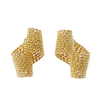 A pair of 18ct gold ear clips. Each designed as mesh-link scroll. Hallmarks for London. Length 2.5cm