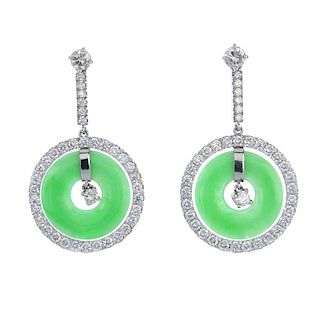 A pair of jade and diamond ear pendants. Each designed as a brilliant-cut diamond, suspended within