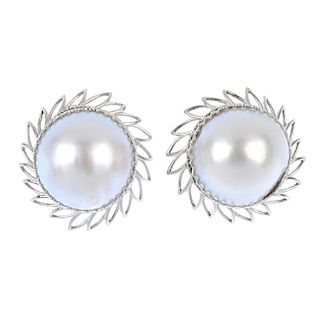A pair of mabe pearl ear clips. Each designed as a mabe pearl, measuring 19mms, within an openwork f