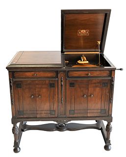 Victrola Phonograph Walnut Cabinet, having several albums of records, in working condition, height 34 1/2 inches, width 37 inches.