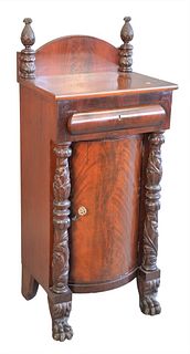 Empire Style Mahogany Cabinet, having one drawer over one door, flanked by heavily carved pillars ending in paw feet, height 49 inches, width 21 inche