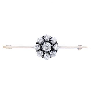 A late 19th century gold diamond cluster bar brooch. The old-cut diamond, within a similarly-cut dia