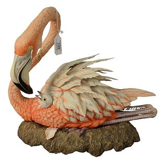 Boehm Porcelain Sculpture of a Nesting Flamingo and Chick, marked, numbered "60" and dated "1987" on the underside, height 13 inches, length 14 inches