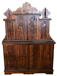 Moorish Carved Four Over Four Door Cabinet, having reticulate carved doors and fret work, height 74 inches, width 53 inches, depth 16 inches.