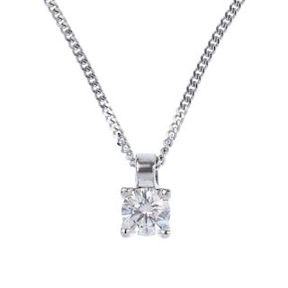A diamond single-stone pendant. The brilliant-cut diamond, to the plain surmount, suspended from a f