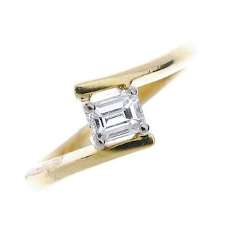 An 18ct gold diamond single-stone crossover ring. The square-shape diamond, to the asymmetric should