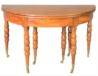 Demilune Extension Table, on eight legs with brass capped feet and wheels, height 30 inches, top open 25" x 51".
