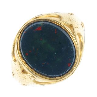 A gentleman's early 20th century 18ct gold bloodstone signet ring. The oval bloodstone panel, to the