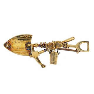 A late 19th century 9ct gold 'digger' brooch. The shovel embossed 'South Africa', with accompanying