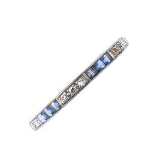An early 20th century sapphire and diamond full-circle eternity ring. Comprising an alternating seri
