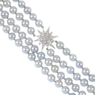 A cultured pearl two-row necklace with 18ct gold diamond clasp. Designed as two rows of forty-eight