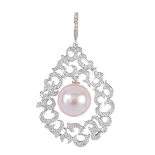 A diamond and cultured pearl pendant. The articulated cultured pearl, measuring 13.8mms, suspended w