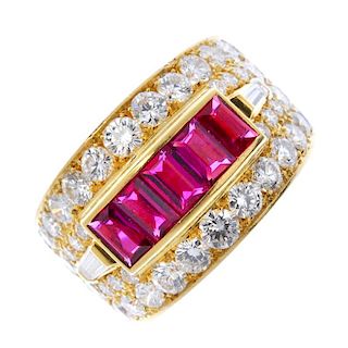 An 18ct gold ruby and diamond dress ring. The rectangular-shape ruby line, within a brilliant-cut di