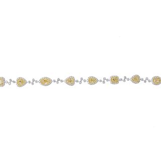* A diamond and coloured diamond bracelet. Designed as a series of vari-shape 'yellow' diamonds, eac
