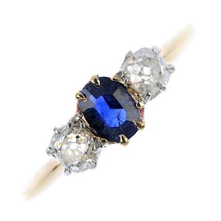 A sapphire and diamond three-stone ring. The oval-shape sapphire, with old-cut diamond sides, to the