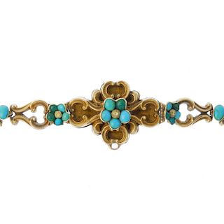A late 19th century gold turquoise bracelet. The turquoise floral cluster, within a scrolling surrou