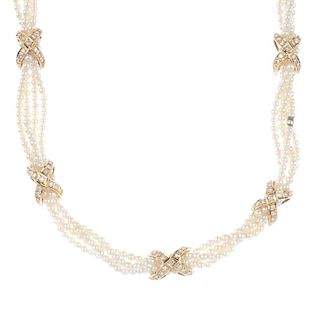 A cultured pearl and diamond four-row necklace. Comprising four-rows of cultured pearls, gathered by