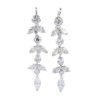 A pair of diamond ear pendants. Each designed with a marquise-shape diamond, suspended from a series